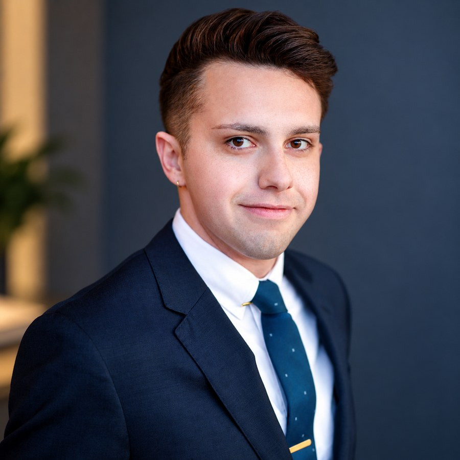 Tareq M Qaraqi in a navy suit and tie.